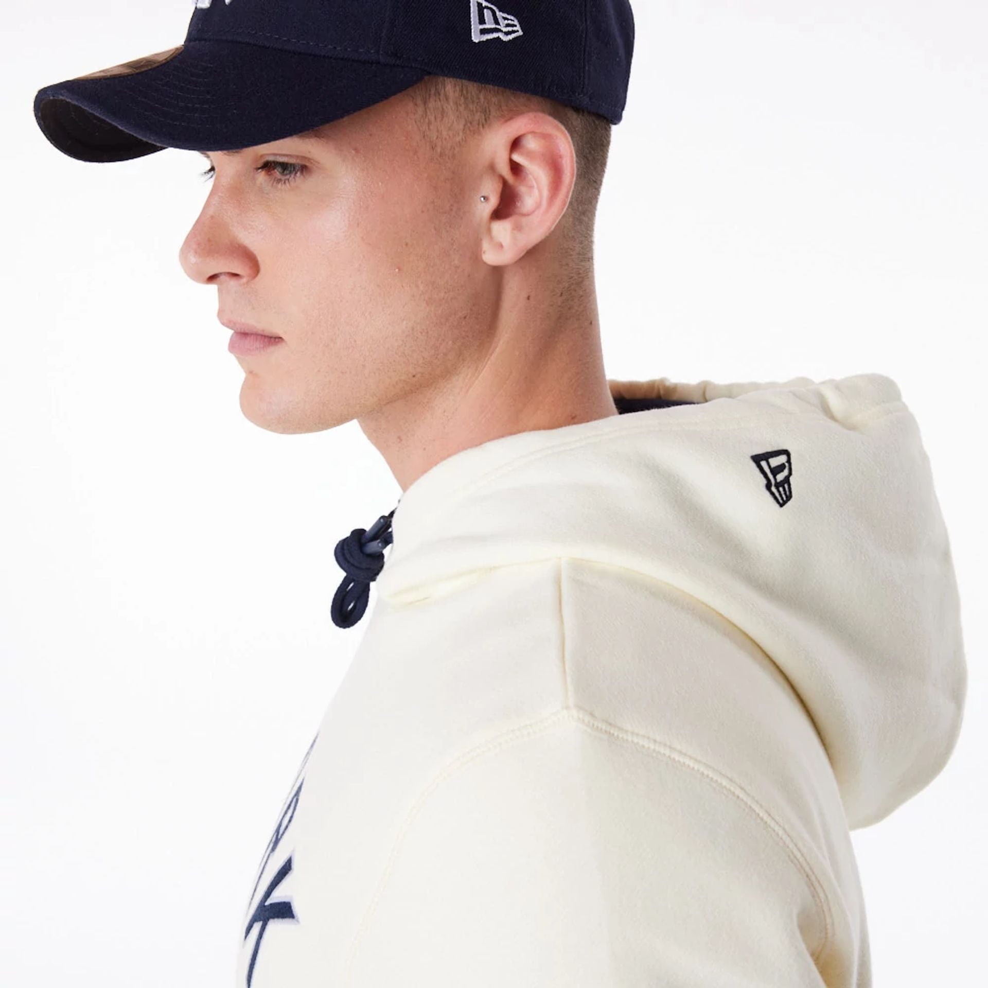 The Male model is wearing New York Yankees MLB Chrome White Pullover Hoodie 2