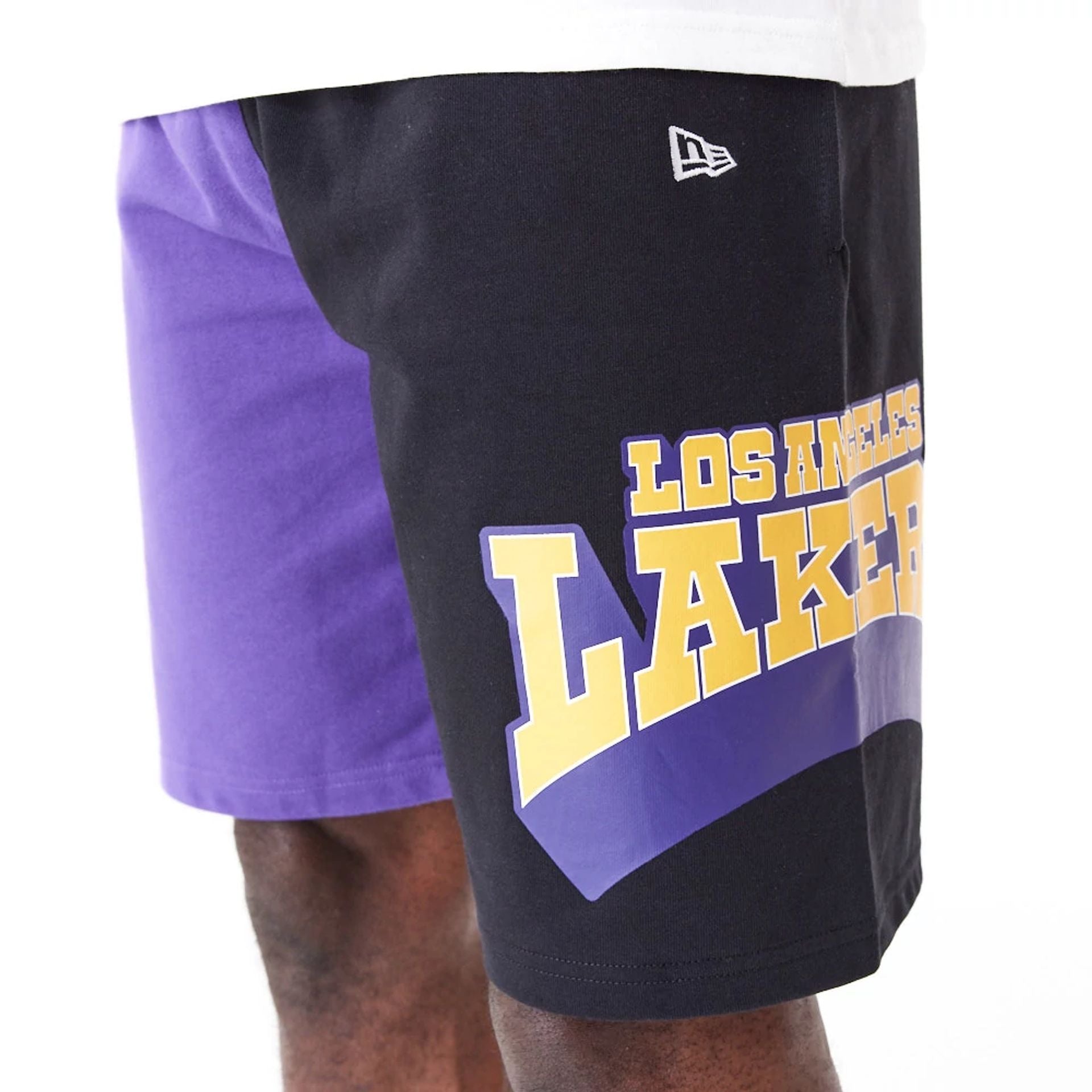 The Male model is wearing LA Lakers NBA Graphic Purple Shorts 4