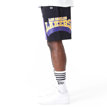 The Male model is wearing LA Lakers NBA Graphic Purple Shorts 6