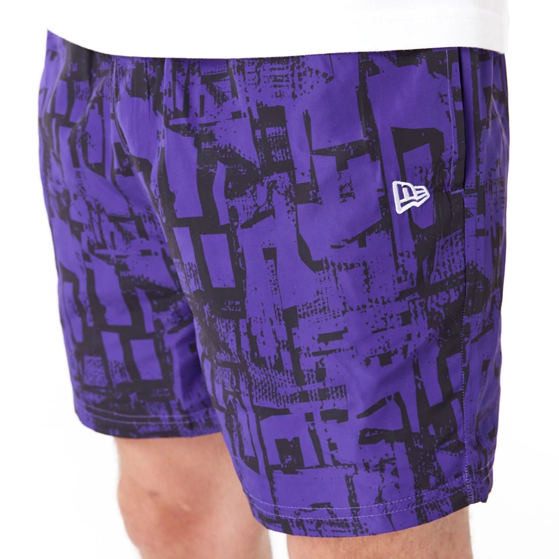 The Male model is wearing LA Lakers NBA All Over Print Purple Shorts 2