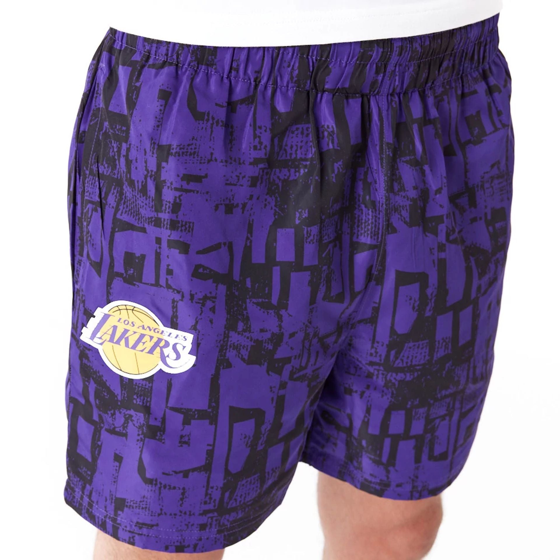 The Male model is wearing LA Lakers NBA All Over Print Purple Shorts 4