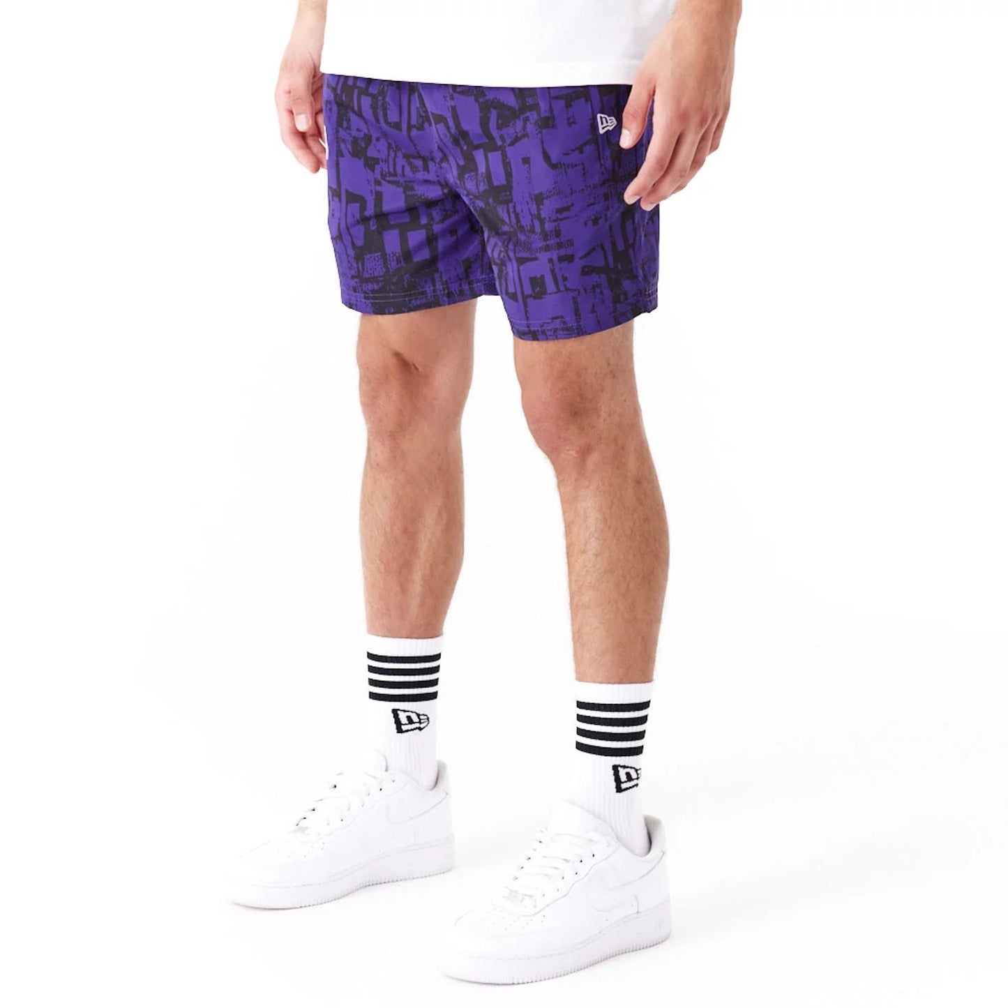 The Male model is wearing LA Lakers NBA All Over Print Purple Shorts 5