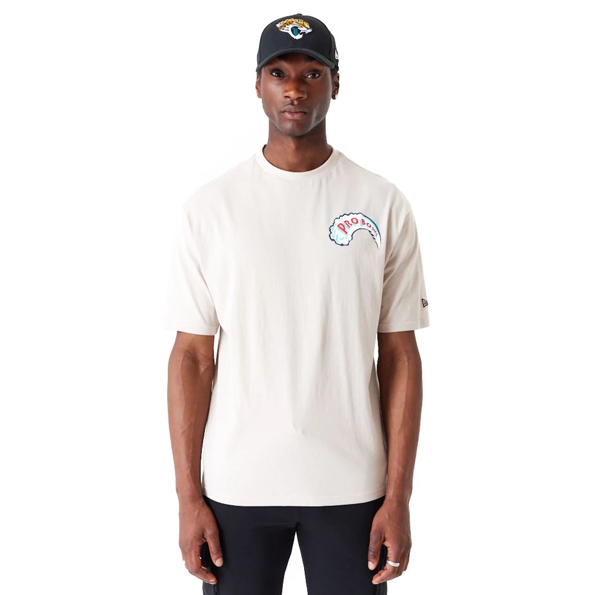 The Male model is wearing NFL Pro Bowl Hawaii NFC Wave Graphic Light Beige Oversized T-Shirt 1