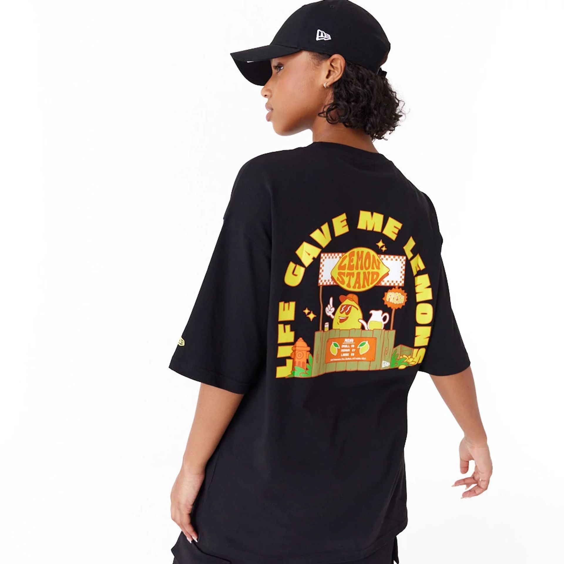 The Male model is wearing New Era Lemon Stand Fruit Graphic Black Oversized T-Shirt 5