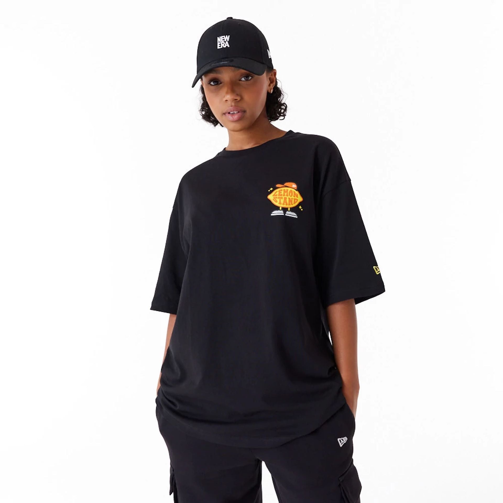 The Male model is wearing New Era Lemon Stand Fruit Graphic Black Oversized T-Shirt 6