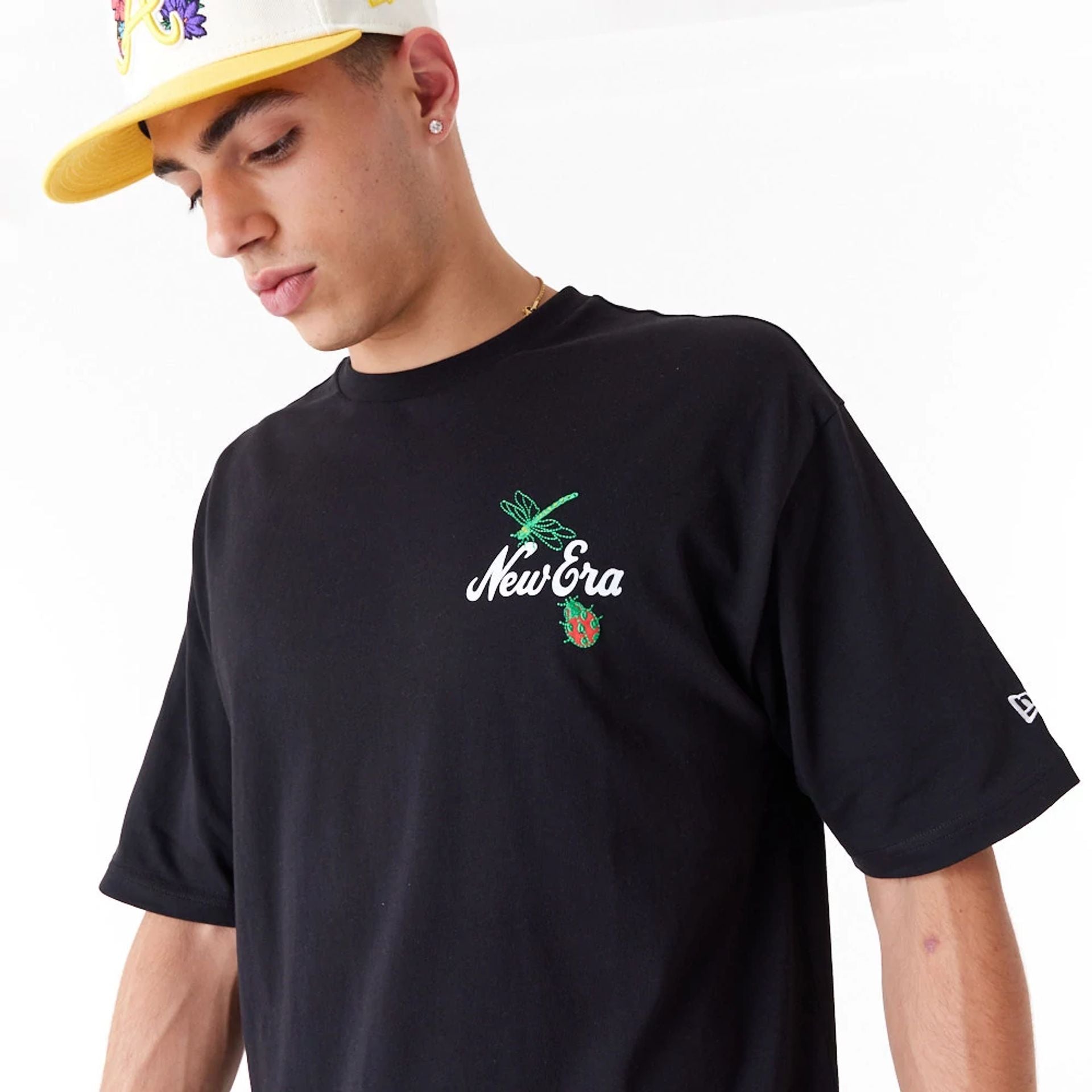 The Male model is wearing New Era Floral Graphic Black Oversized T-Shirt 5