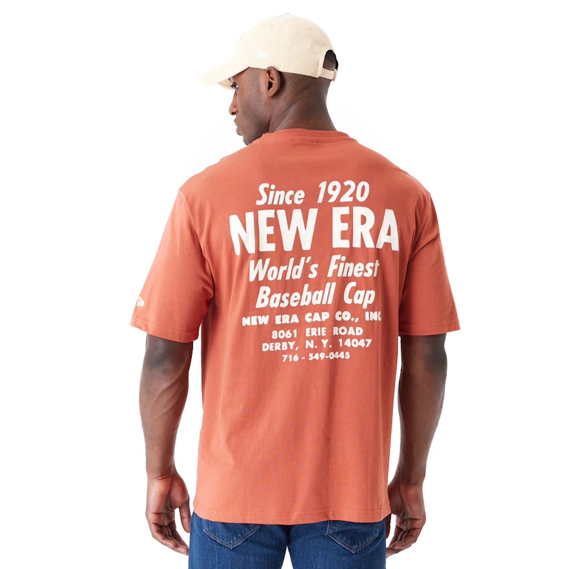 The Male model is wearing New Era Graphic Brown Oversized T-Shirt 2