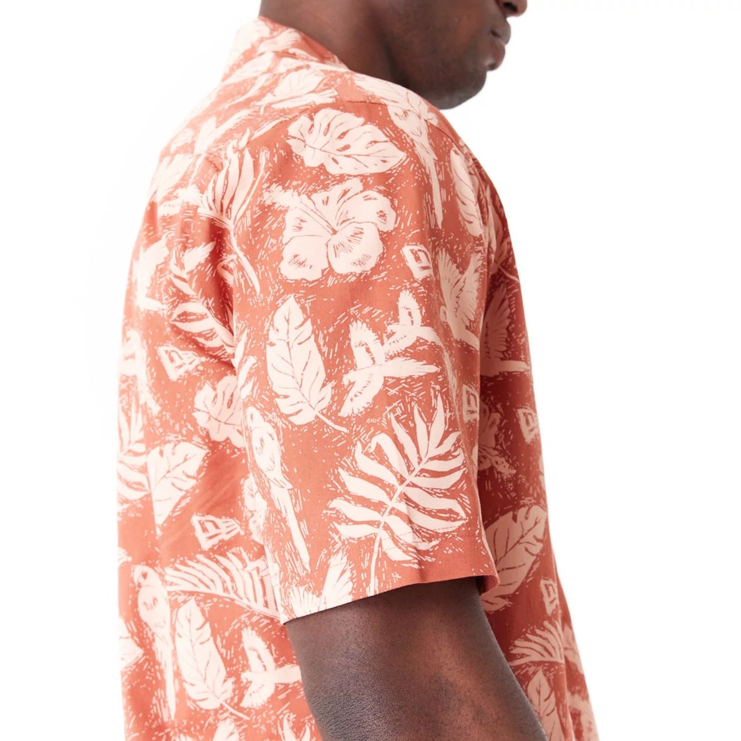 The Male model is wearing New Era All Over Print Brown Woven Short Sleeve Shirt 7