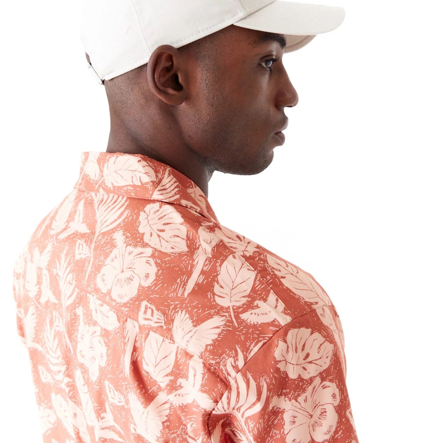 The Male model is wearing New Era All Over Print Brown Woven Short Sleeve Shirt 6