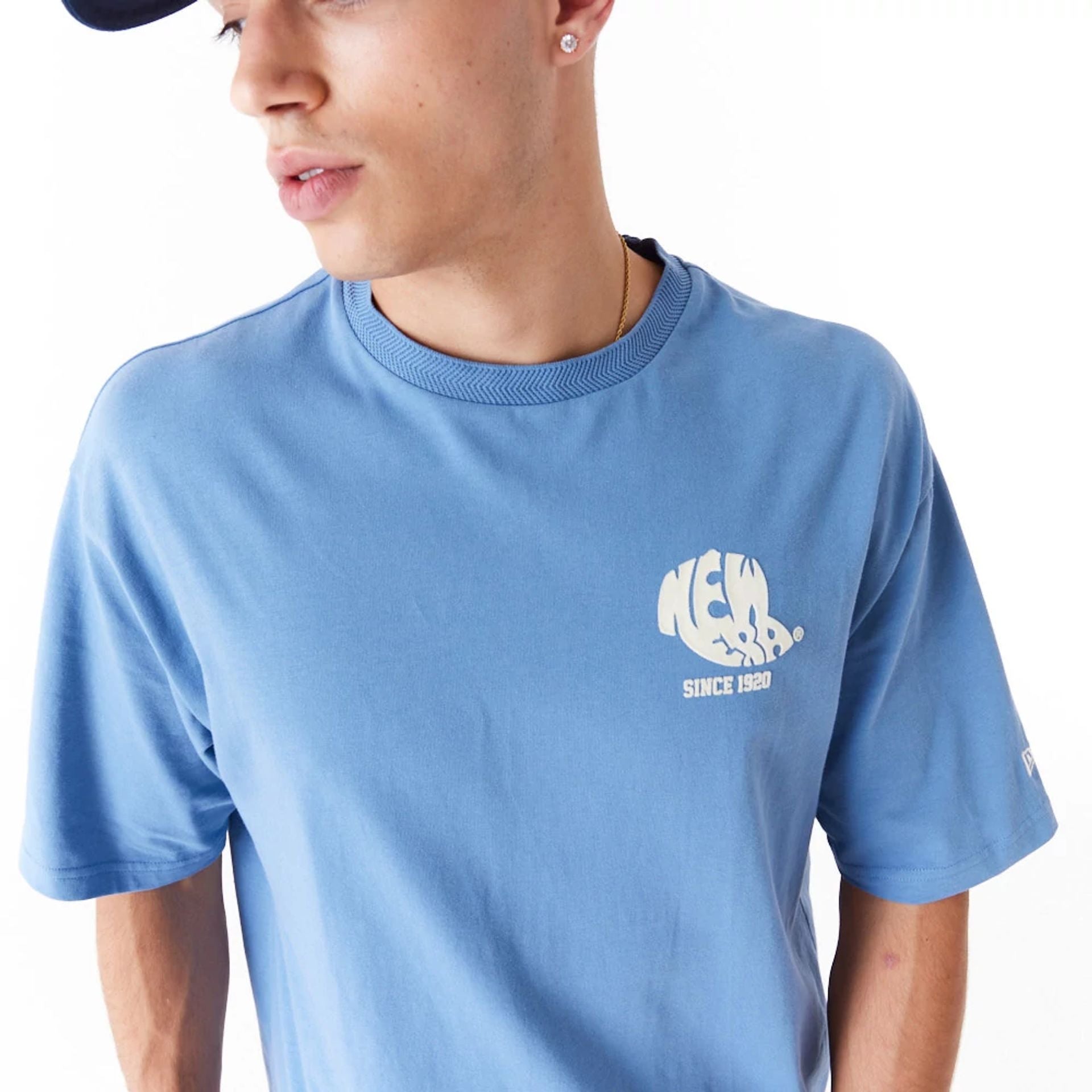 The Male model is wearing New Era Graphic Blue Oversized T-Shirt 2