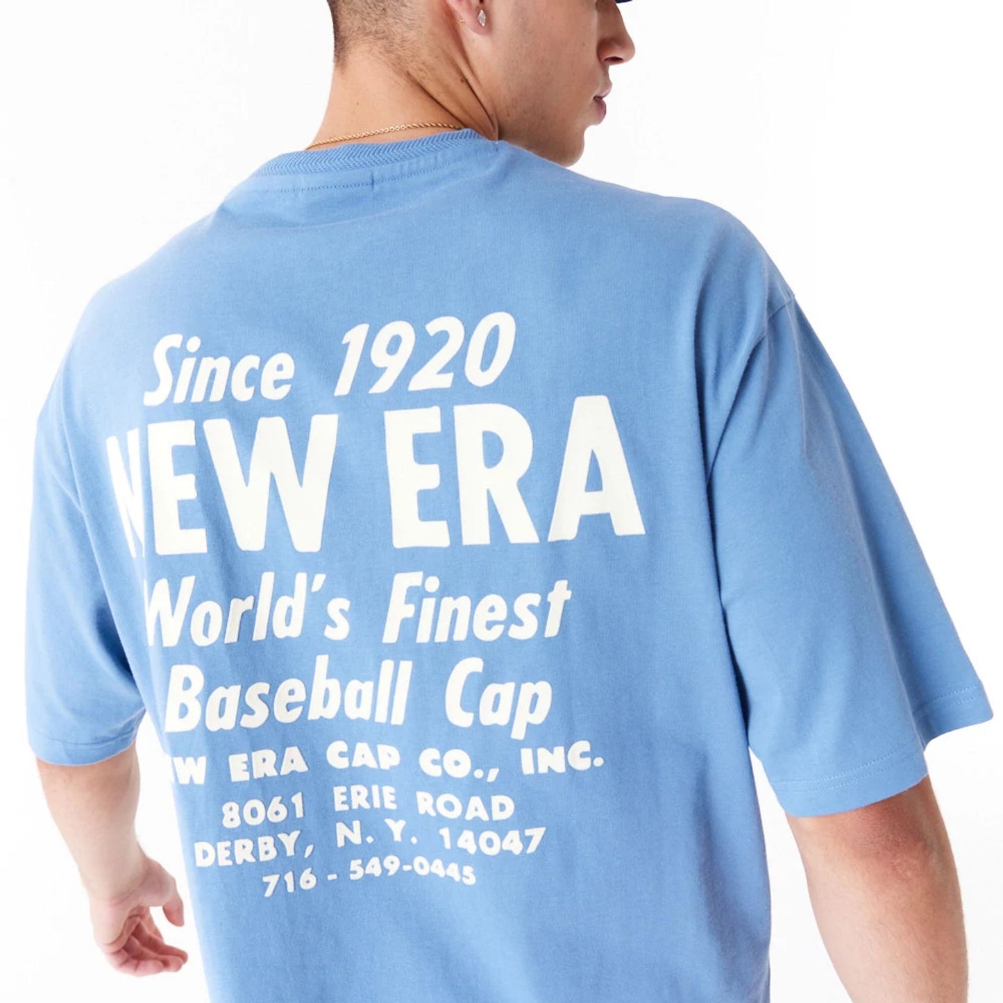 The Male model is wearing New Era Graphic Blue Oversized T-Shirt 4