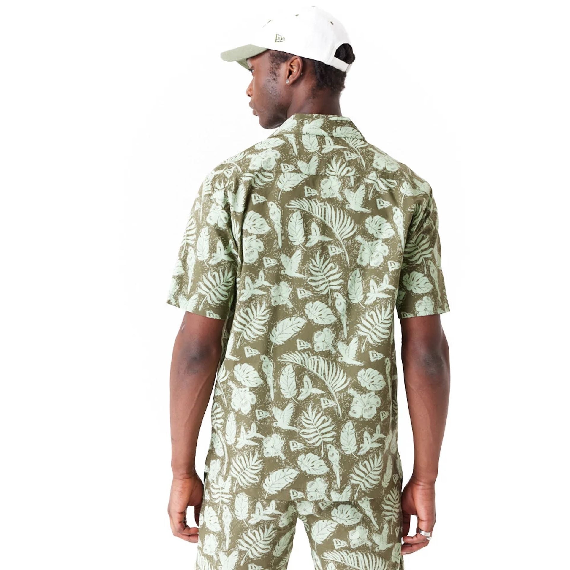 The Male model is wearing New Era All Over Print Green Woven Short Sleeve Shirt 6