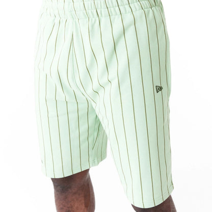 The Male model is wearing New Era Pinstripe Bright Green Shorts 5