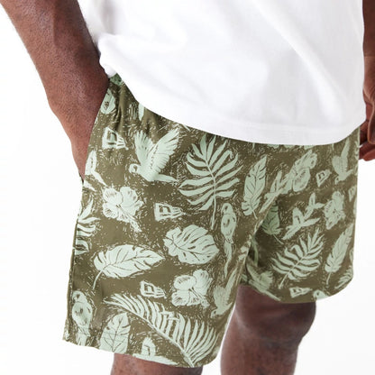 The Male model is wearing New Era All Over Print Green Woven Shorts 3