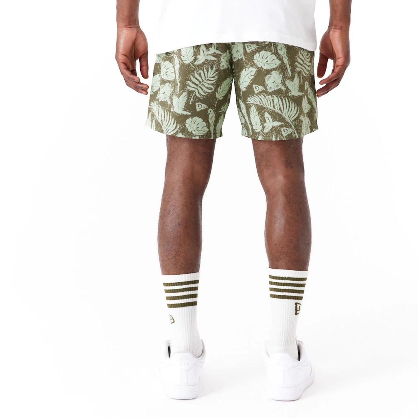 The Male model is wearing New Era All Over Print Green Woven Shorts 8