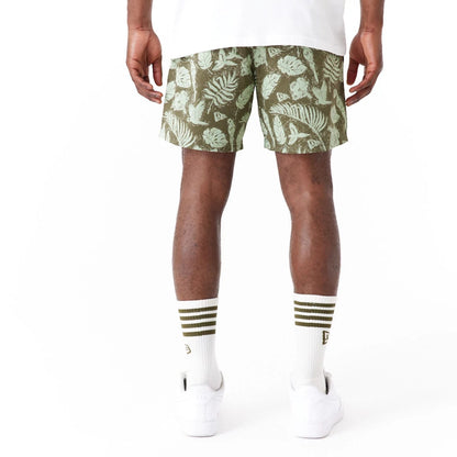 The Male model is wearing New Era All Over Print Green Woven Shorts 8