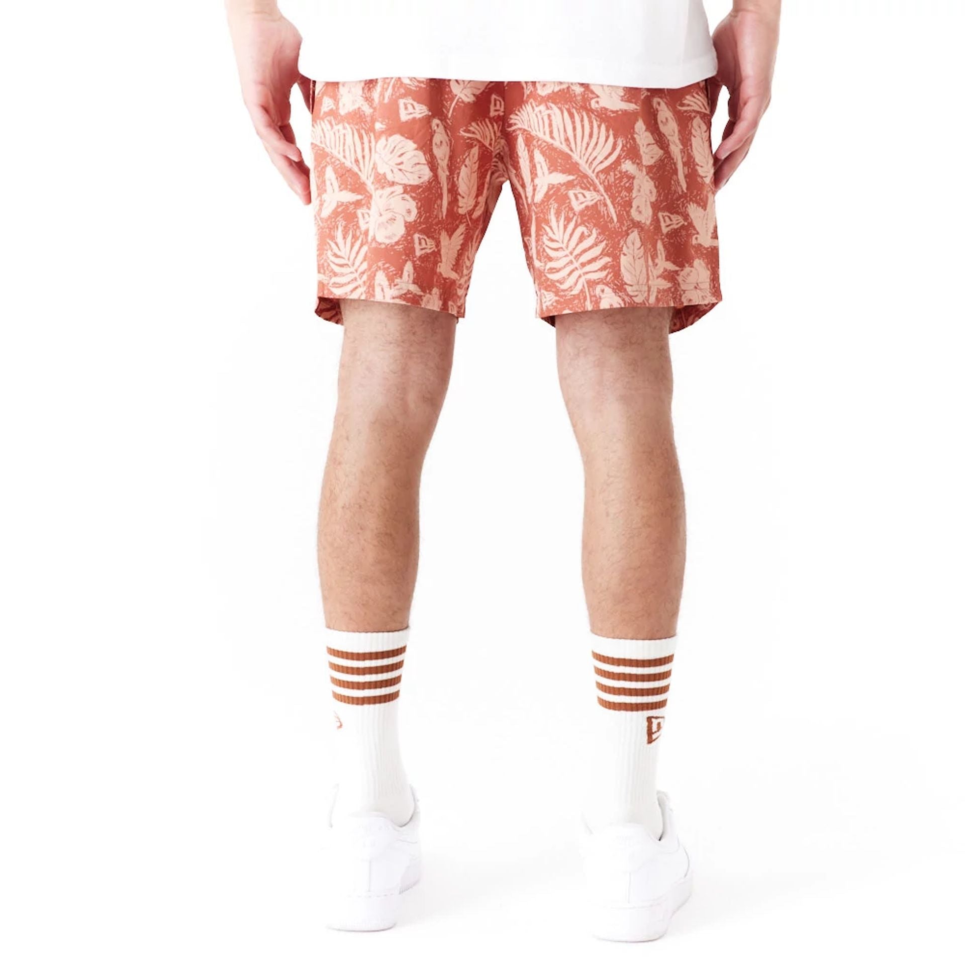 The Male model is wearing New Era All Over Print Brown Woven Shorts 7