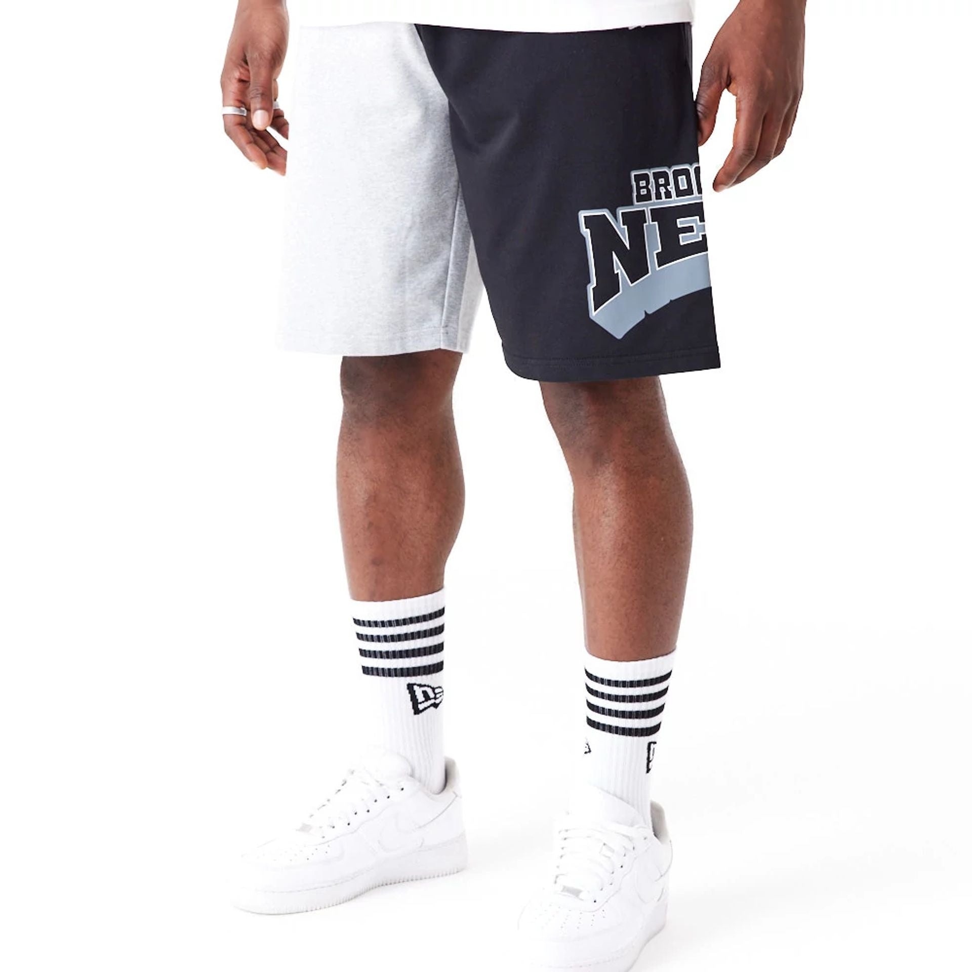 The Male model is wearing Brooklyn Nets NBA Graphic Grey Shorts 1