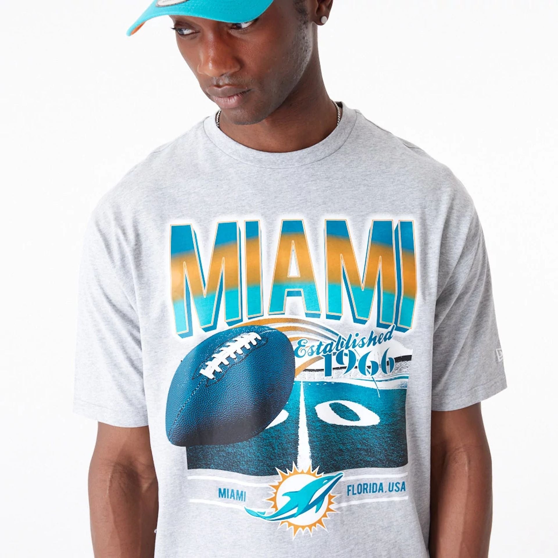 The Male model is wearing Miami Dolphins NFL Team Graphic Grey Oversized T-Shirt 3