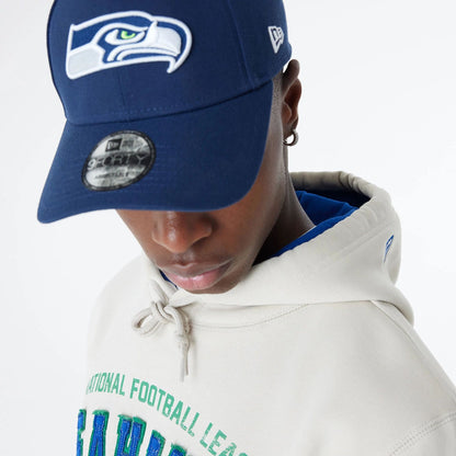 The Male model is wearing Seattle Seahawks NFL 3rd Down Historic Light Beige Pullover Hoodie  7