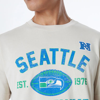 The Male model is wearing Seattle Seahawks NFL 3rd Down Historic Light Beige T-Shirt  6