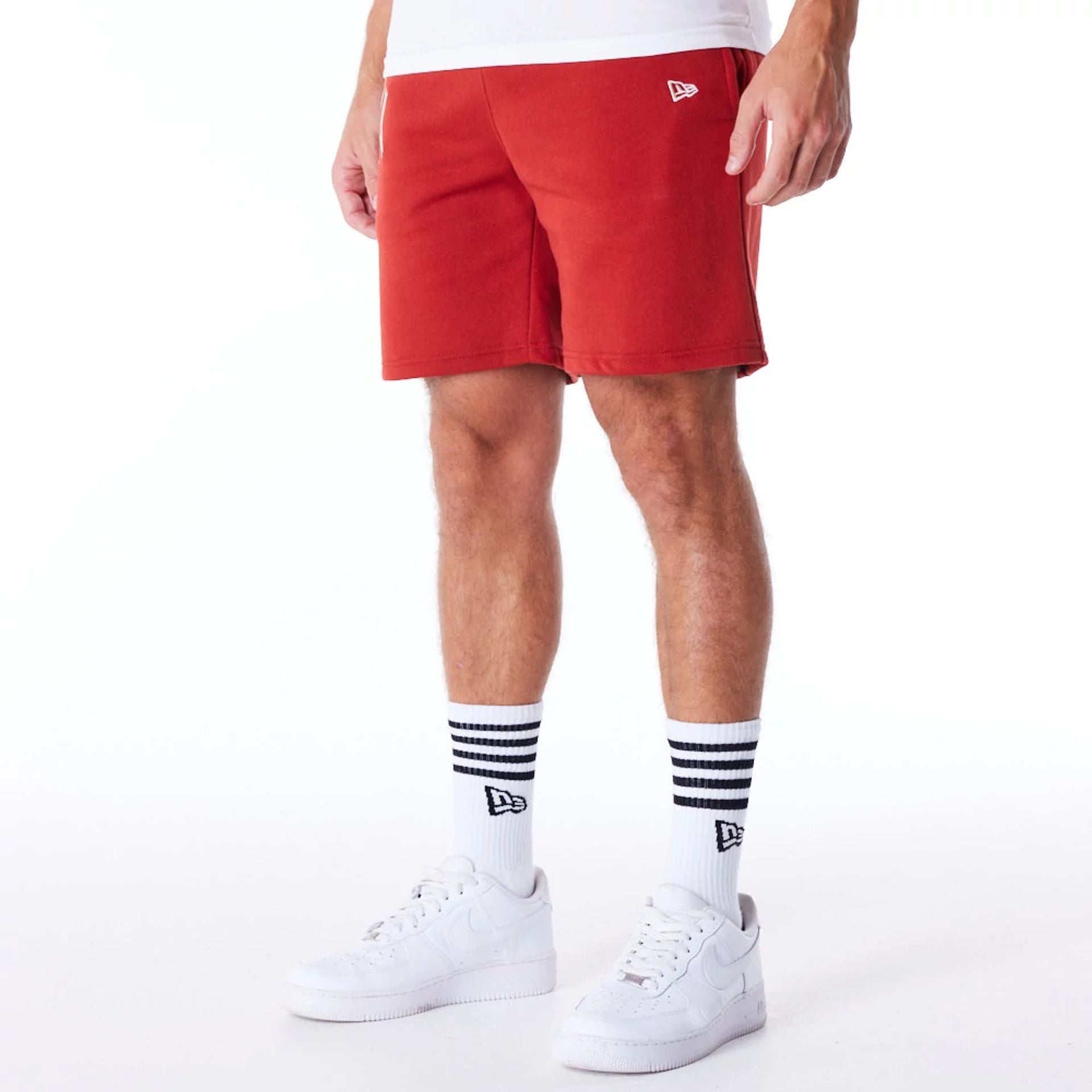 The Male model is wearing New York Yankees League Essential Red Shorts 2