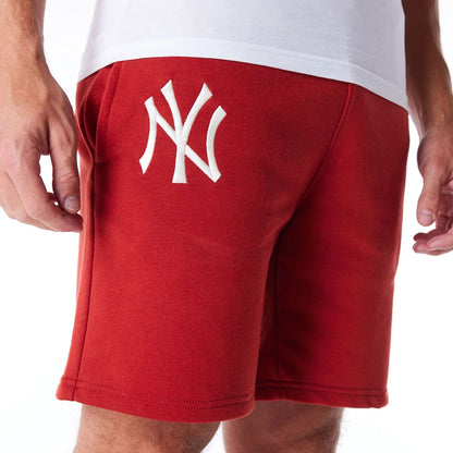 The Male model is wearing New York Yankees League Essential Red Shorts 3