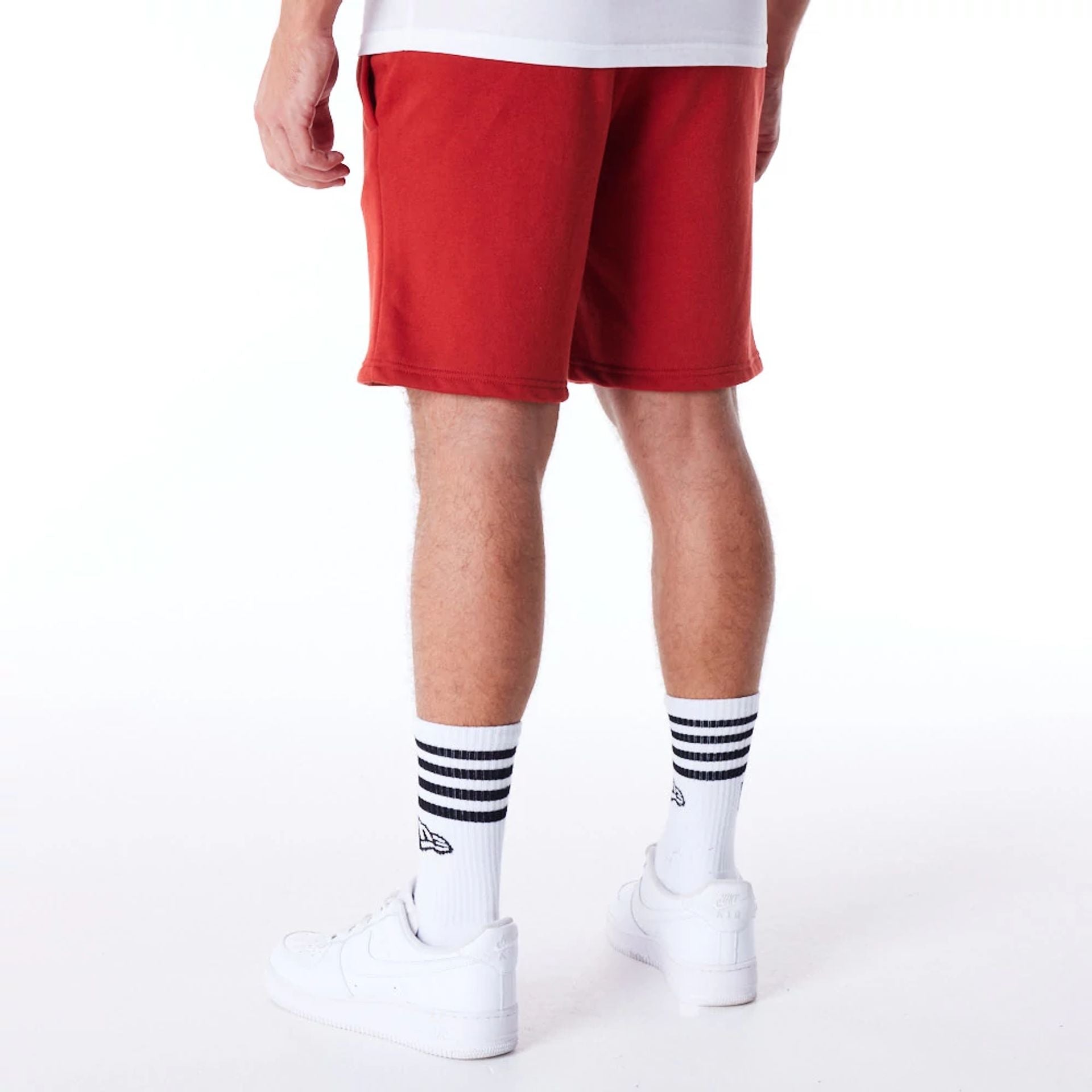 The Male model is wearing New York Yankees League Essential Red Shorts 7