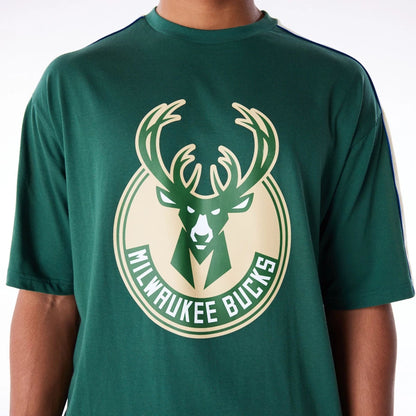 The Male model is wearing Milwaukee Bucks NBA Panel Dark Green Oversized T-Shirt 6