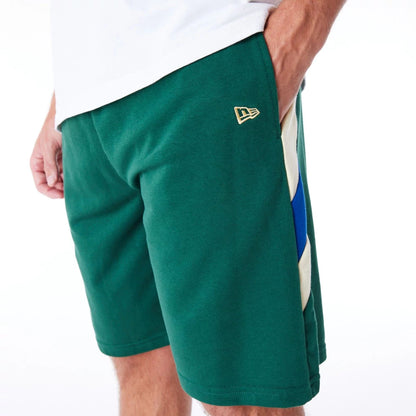 The Male model is wearing Milwaukee Bucks NBA Panel Dark Green Oversized Shorts 3