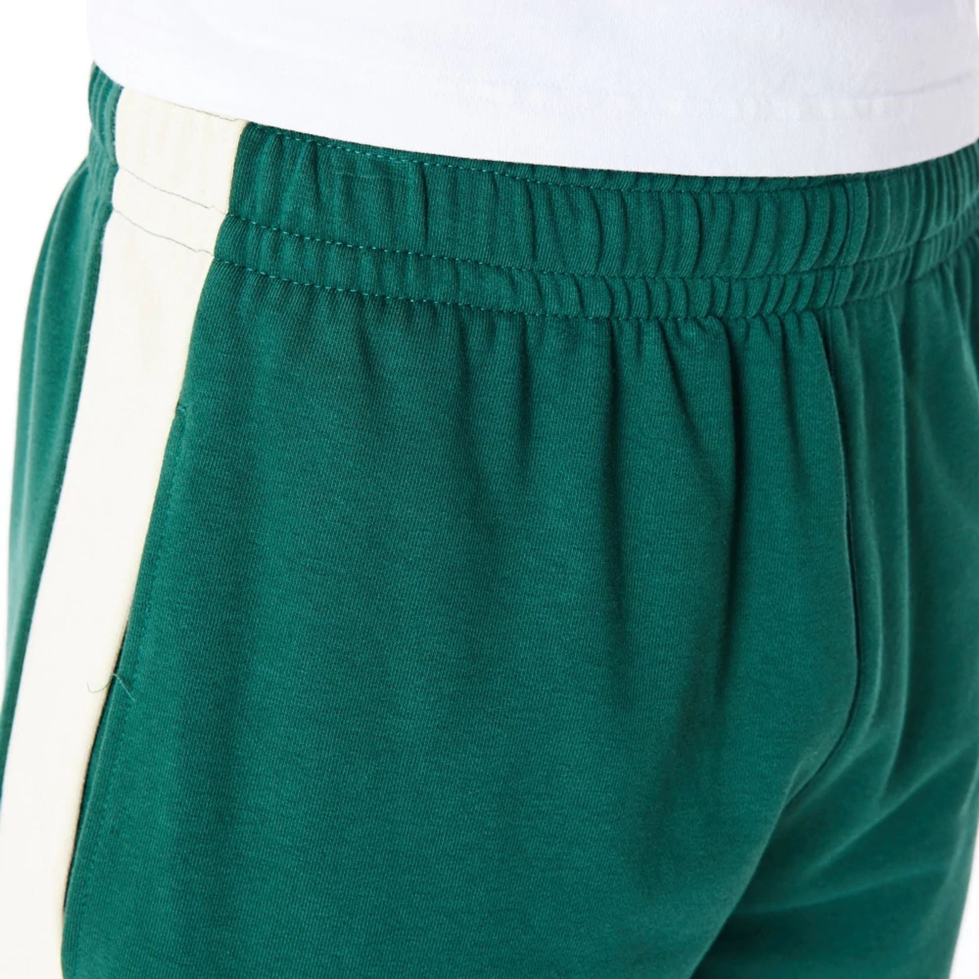 The Male model is wearing Milwaukee Bucks NBA Panel Dark Green Oversized Shorts 5