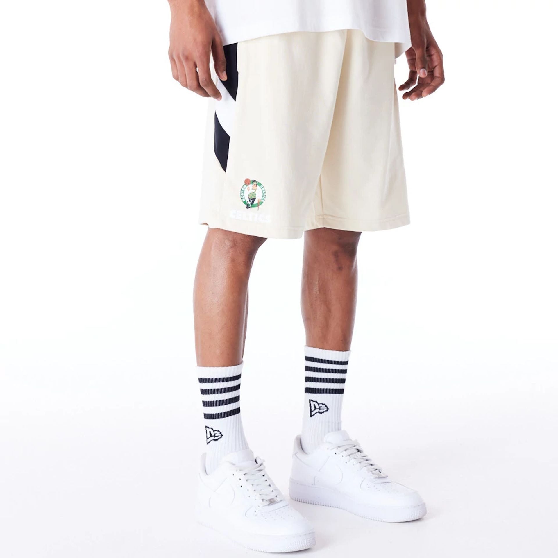 The Male model is wearing Boston Celtics NBA Panel Stone Oversized Shorts 7