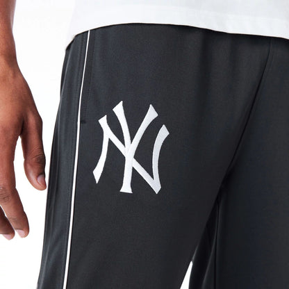 The Male model is wearing New York Yankees MLB Track Pant Black Fleece Track Joggers 2