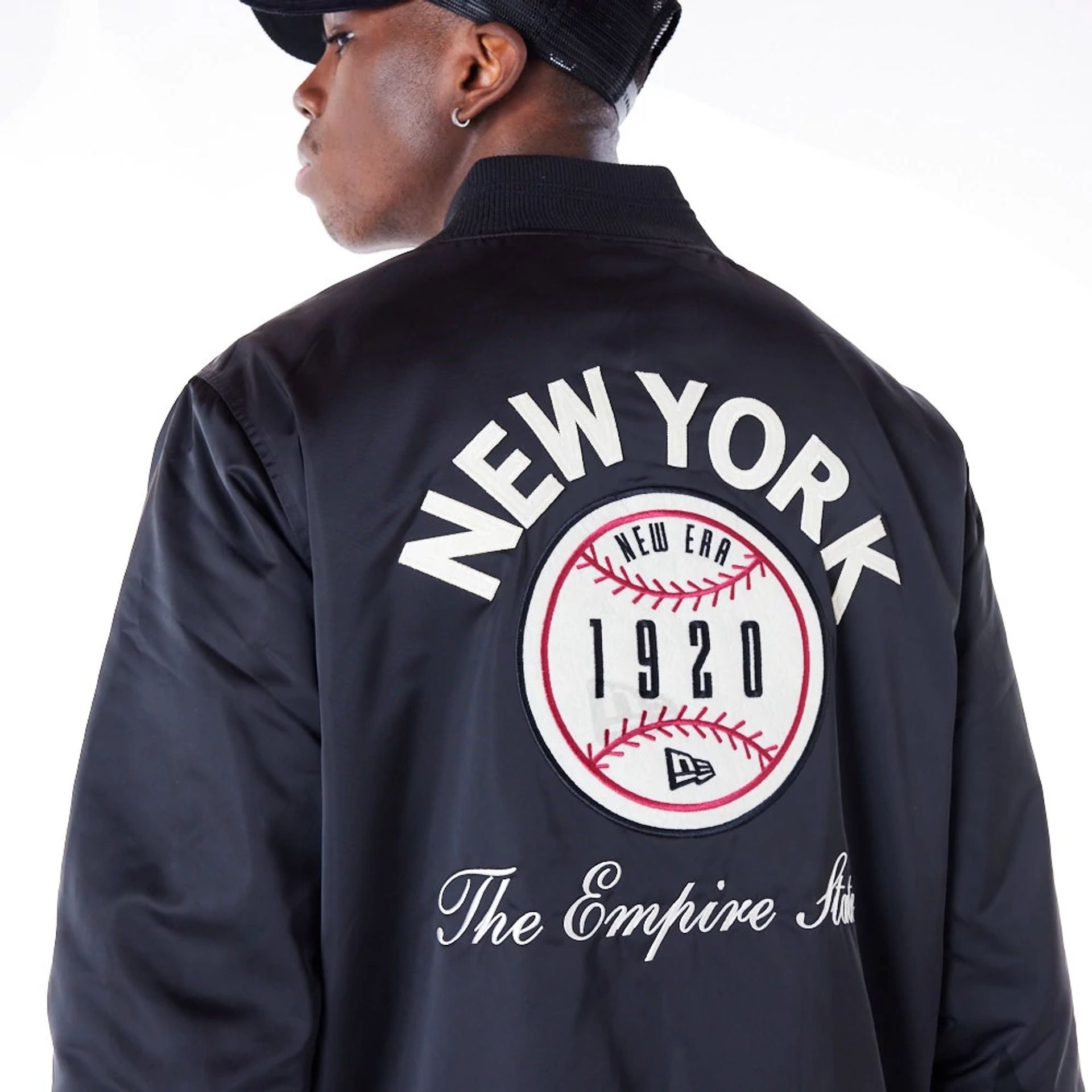 The Male model is wearing New Era Satin Graphic Black Bomber Jacket 2