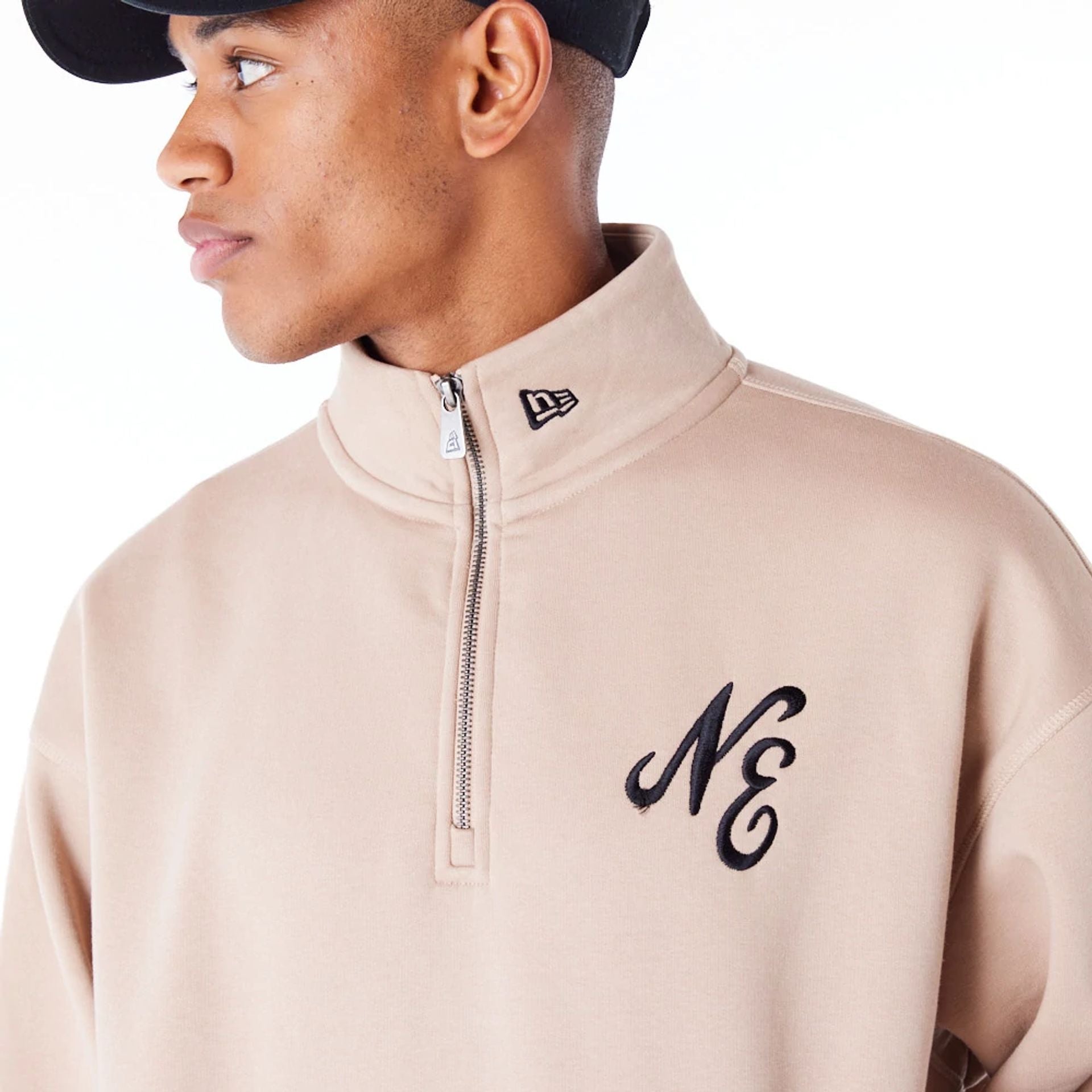 The Male model is wearing New Era Lifestyle Beige Quarter-Zip Sweater 2