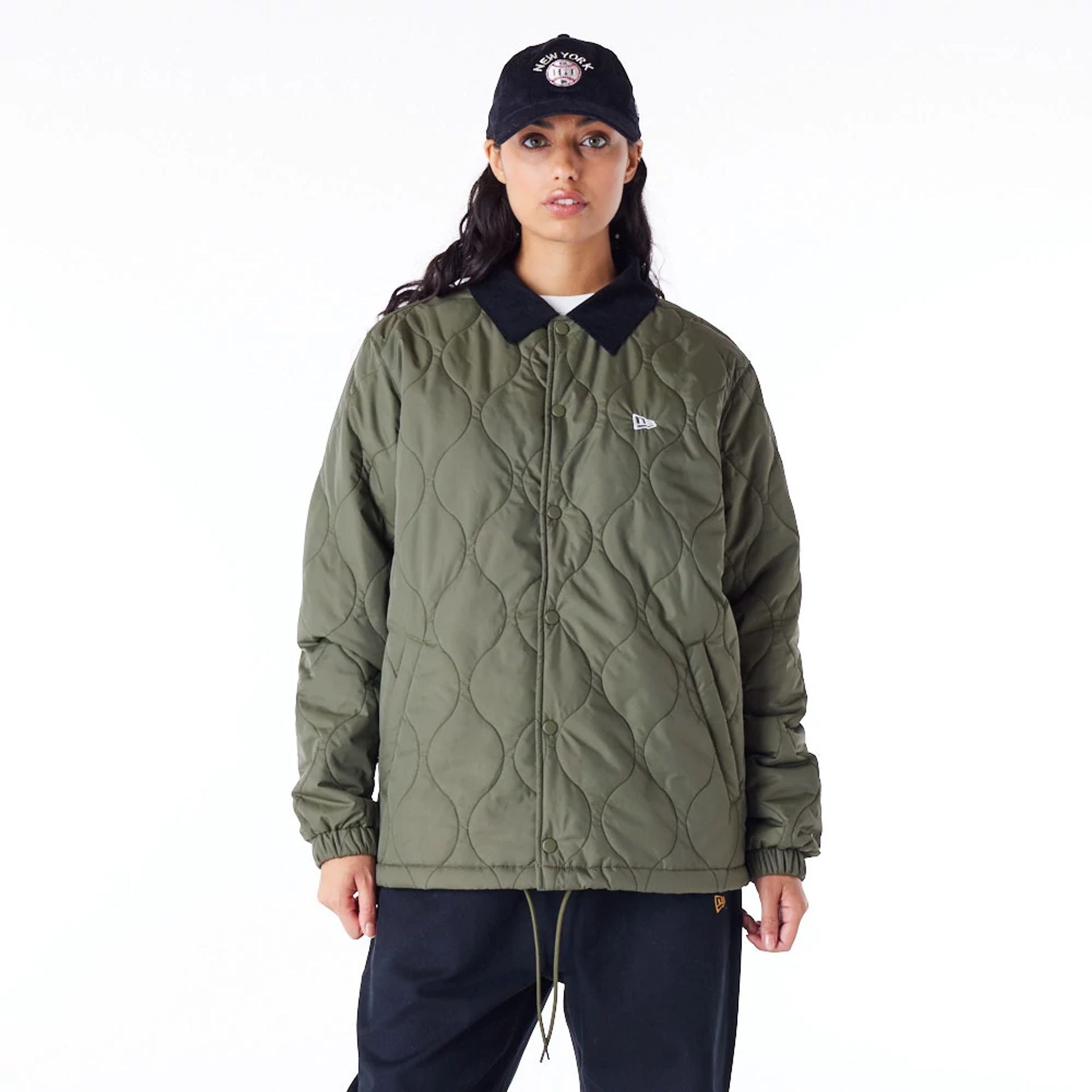 The Male model is wearing New Era Green Quilted Coach Jacket 2