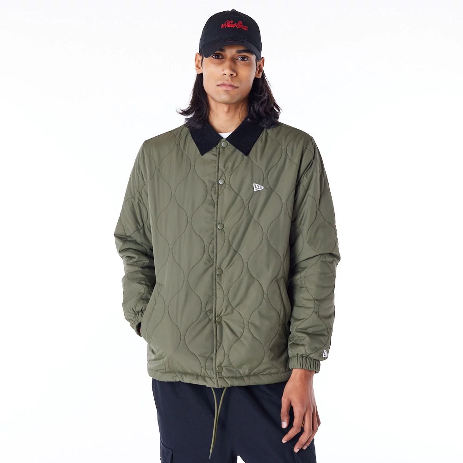 The Male model is wearing New Era Green Quilted Coach Jacket 3