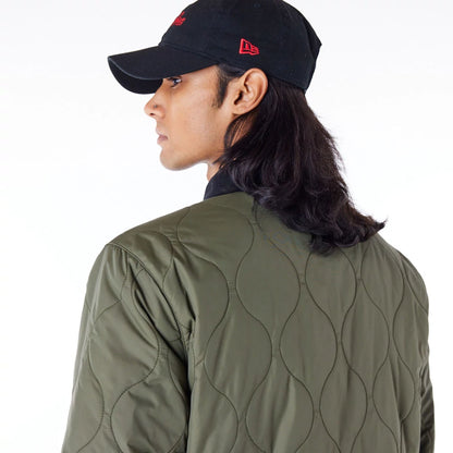 The Male model is wearing New Era Green Quilted Coach Jacket 6