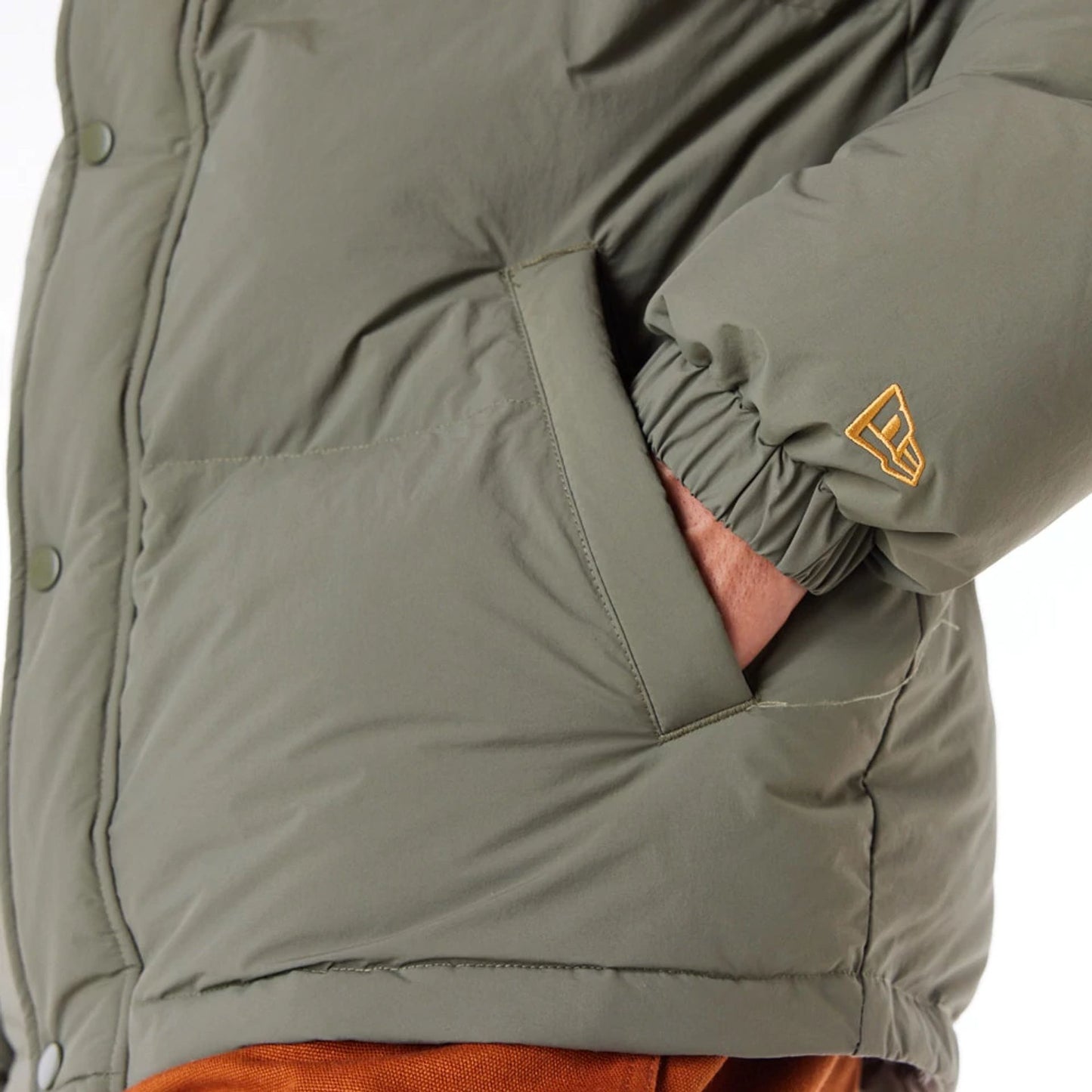 The Male model is wearing New Era Green Canvas Puffer Jacket 4