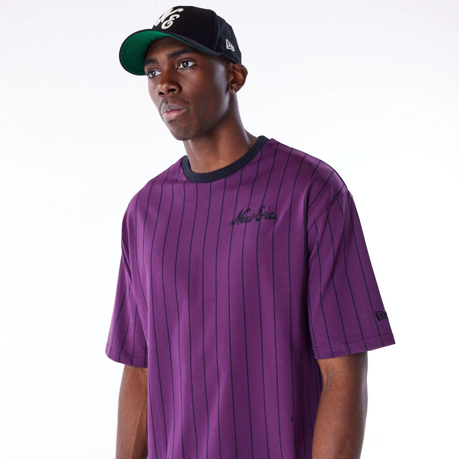 The Male model is wearing New Era Pinstripe Dark Purple Oversized T-Shirt 5