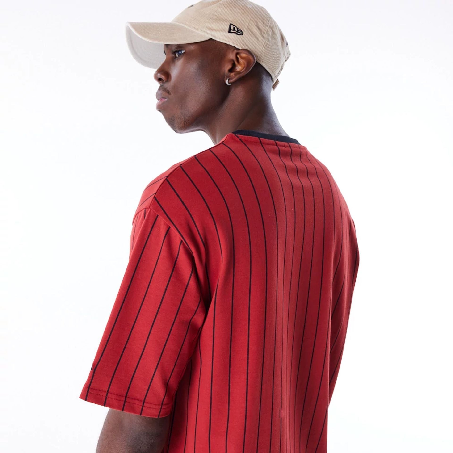 The Male model is wearing New Era Pinstripe Red Oversized T-Shirt 4