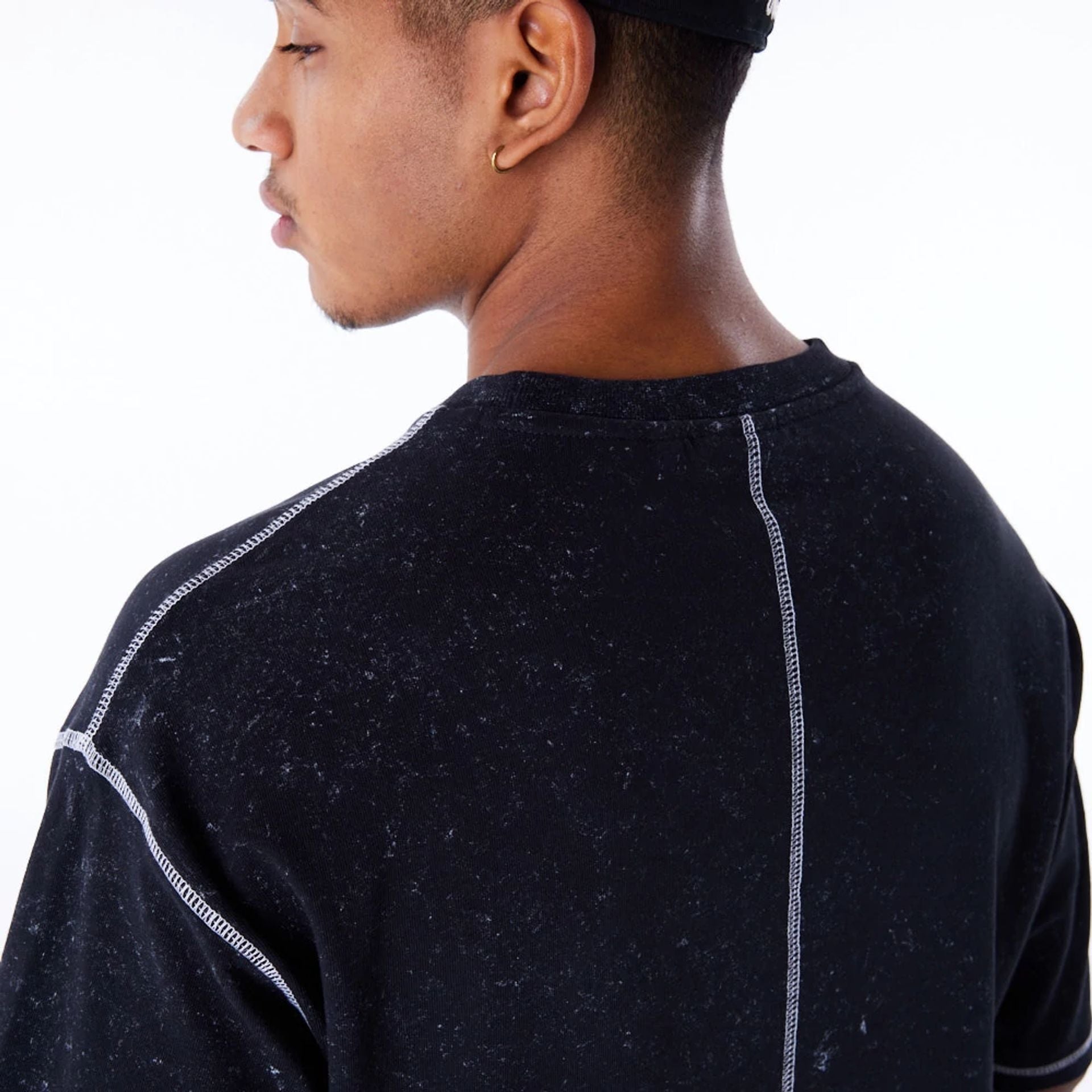 The Male model is wearing New Era Wash Black Oversized T-Shirt 2