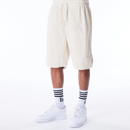 The Male model is wearing New Era Mesh Stone Oversized Shorts 1