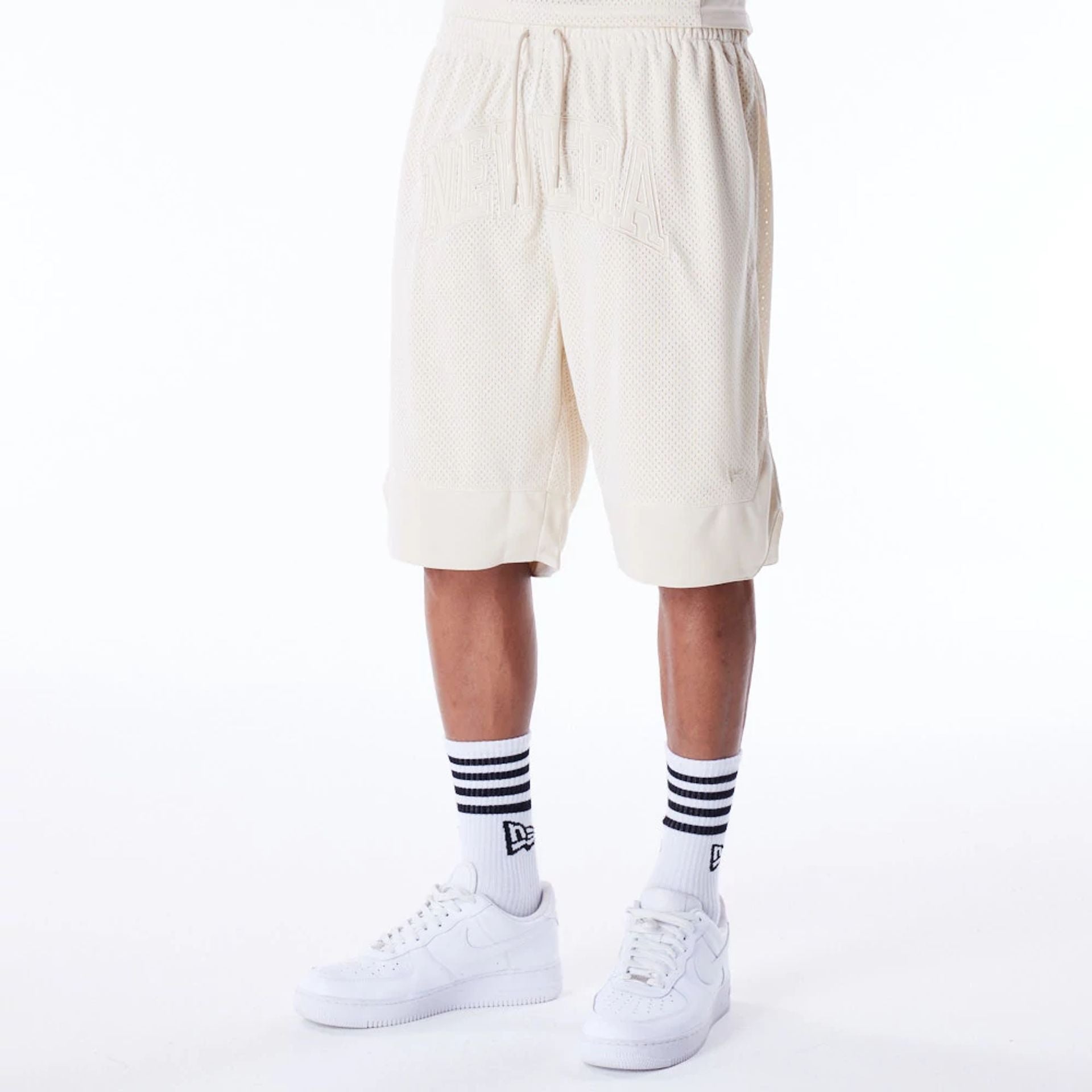 The Male model is wearing New Era Mesh Stone Oversized Shorts 1