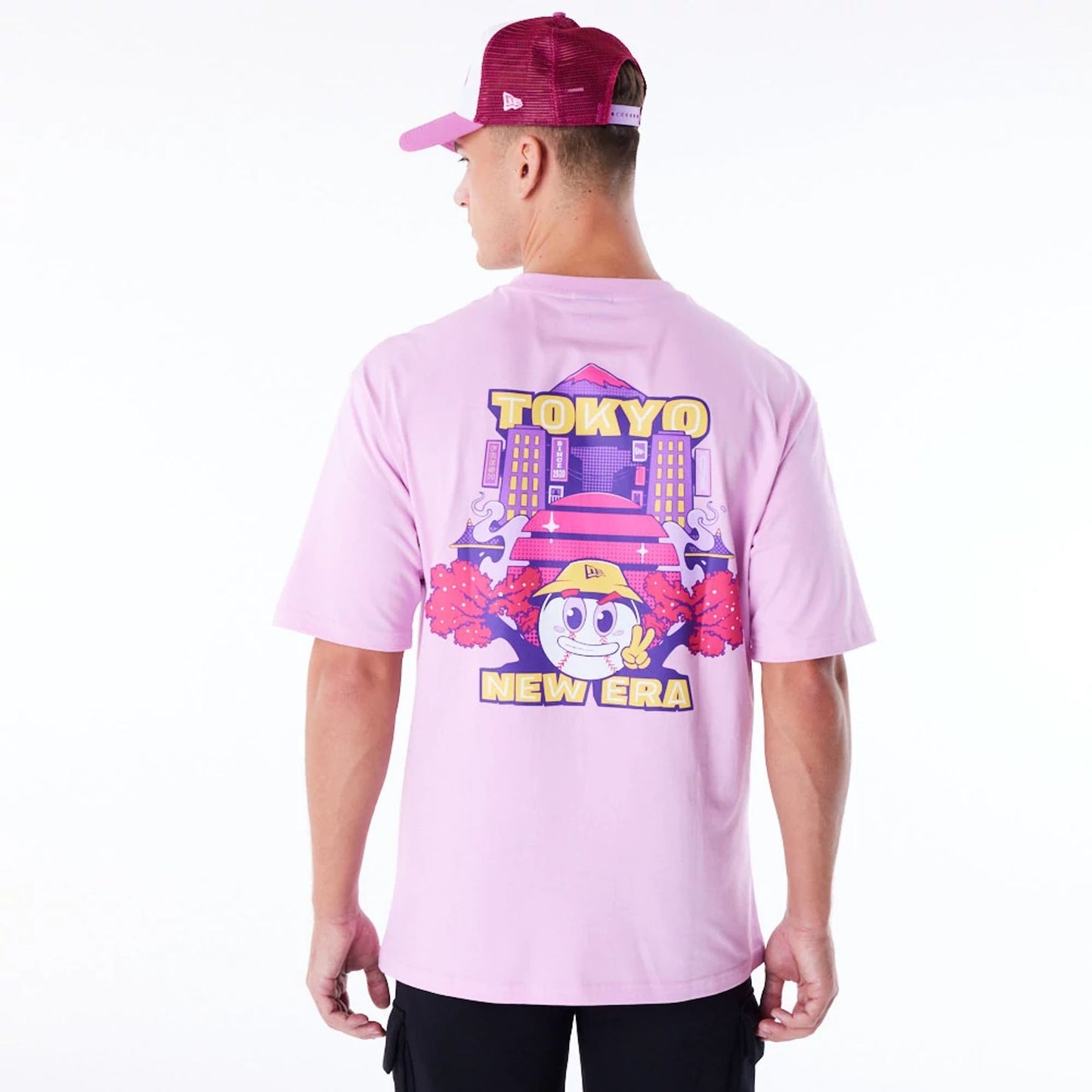 The Male model is wearing New Era Location Graphic Tokyo Pastel Pink Oversized T-Shirt 2