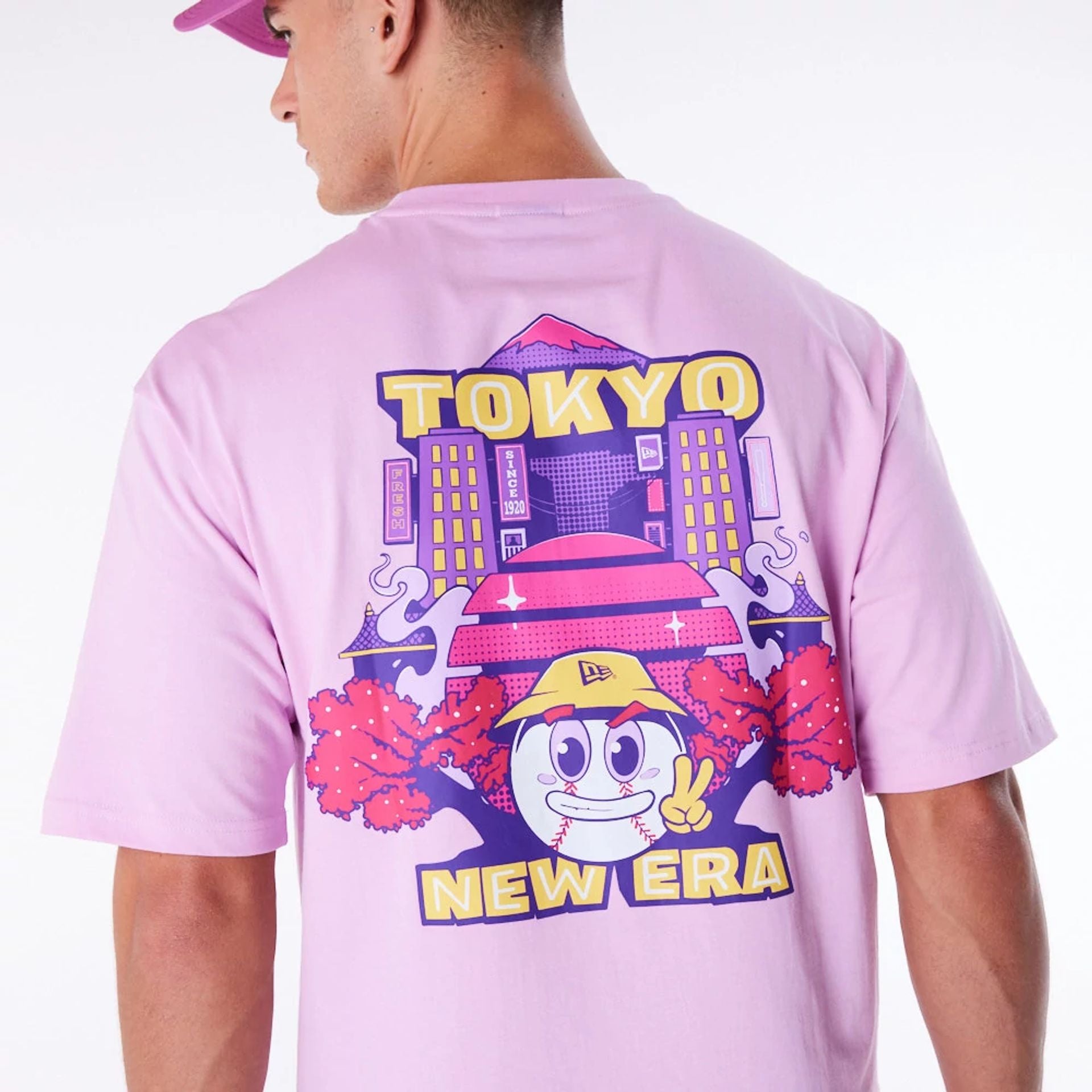 The Male model is wearing New Era Location Graphic Tokyo Pastel Pink Oversized T-Shirt 4