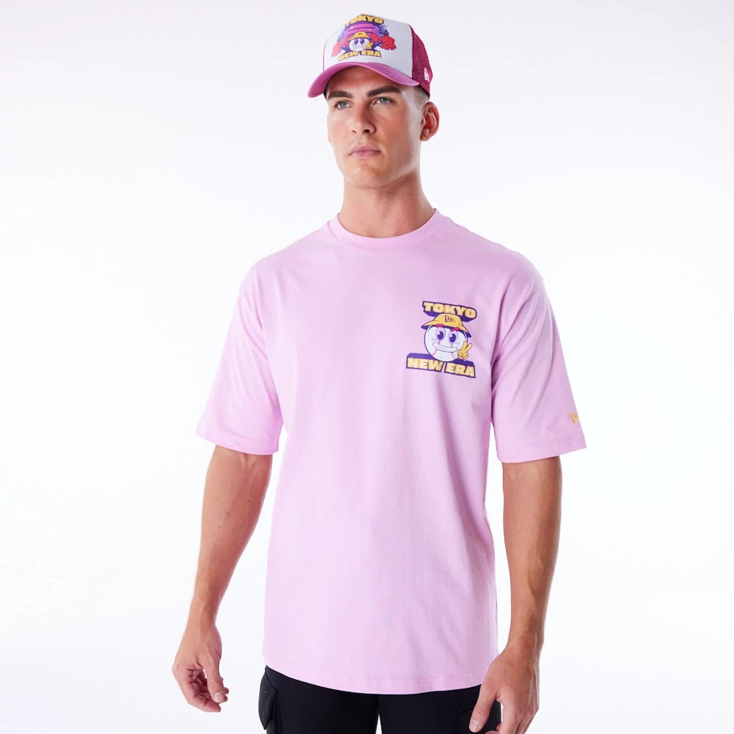 The Male model is wearing New Era Location Graphic Tokyo Pastel Pink Oversized T-Shirt 1