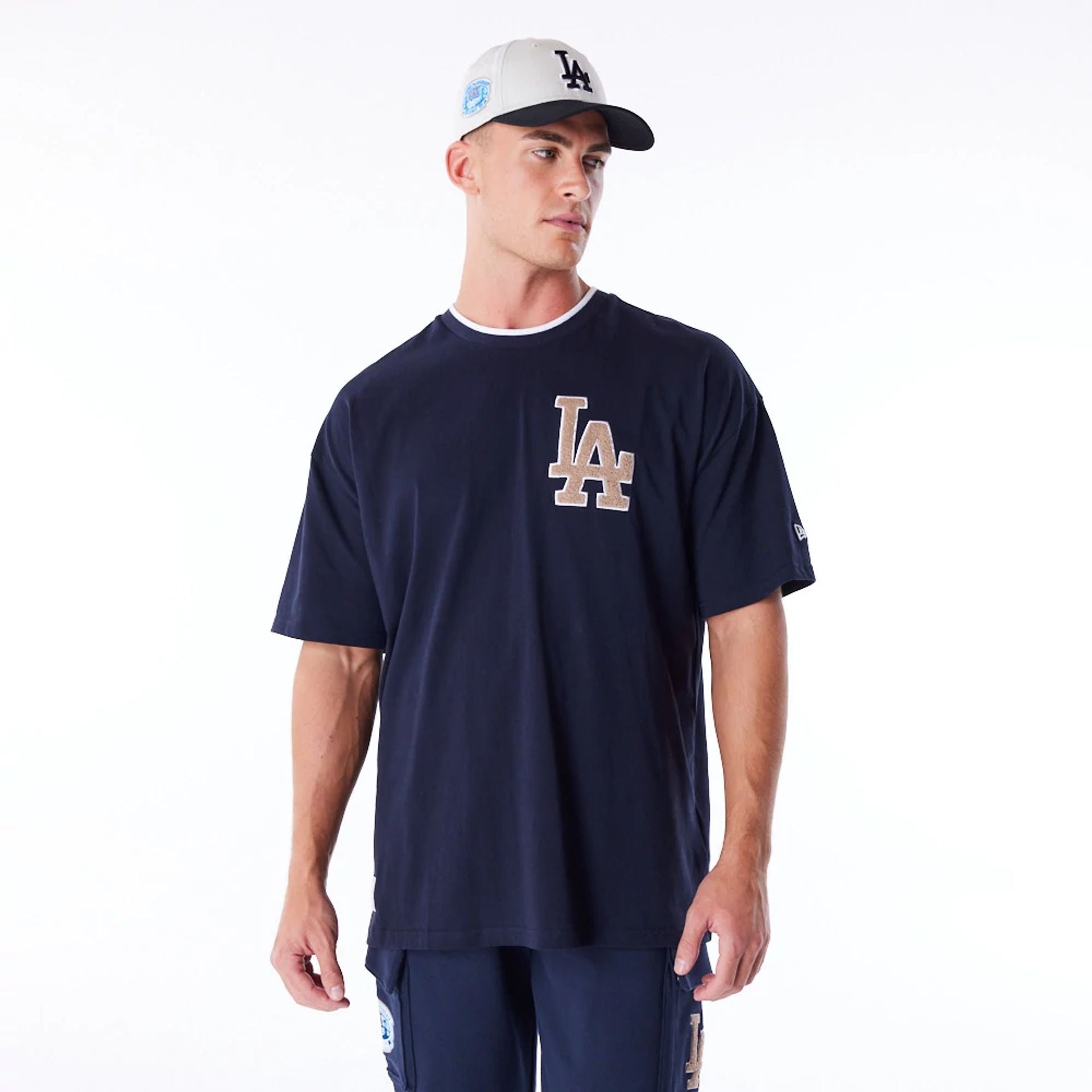 The Male model is wearing LA Dodgers World Series Navy Drop Shoulder T-Shirt  1