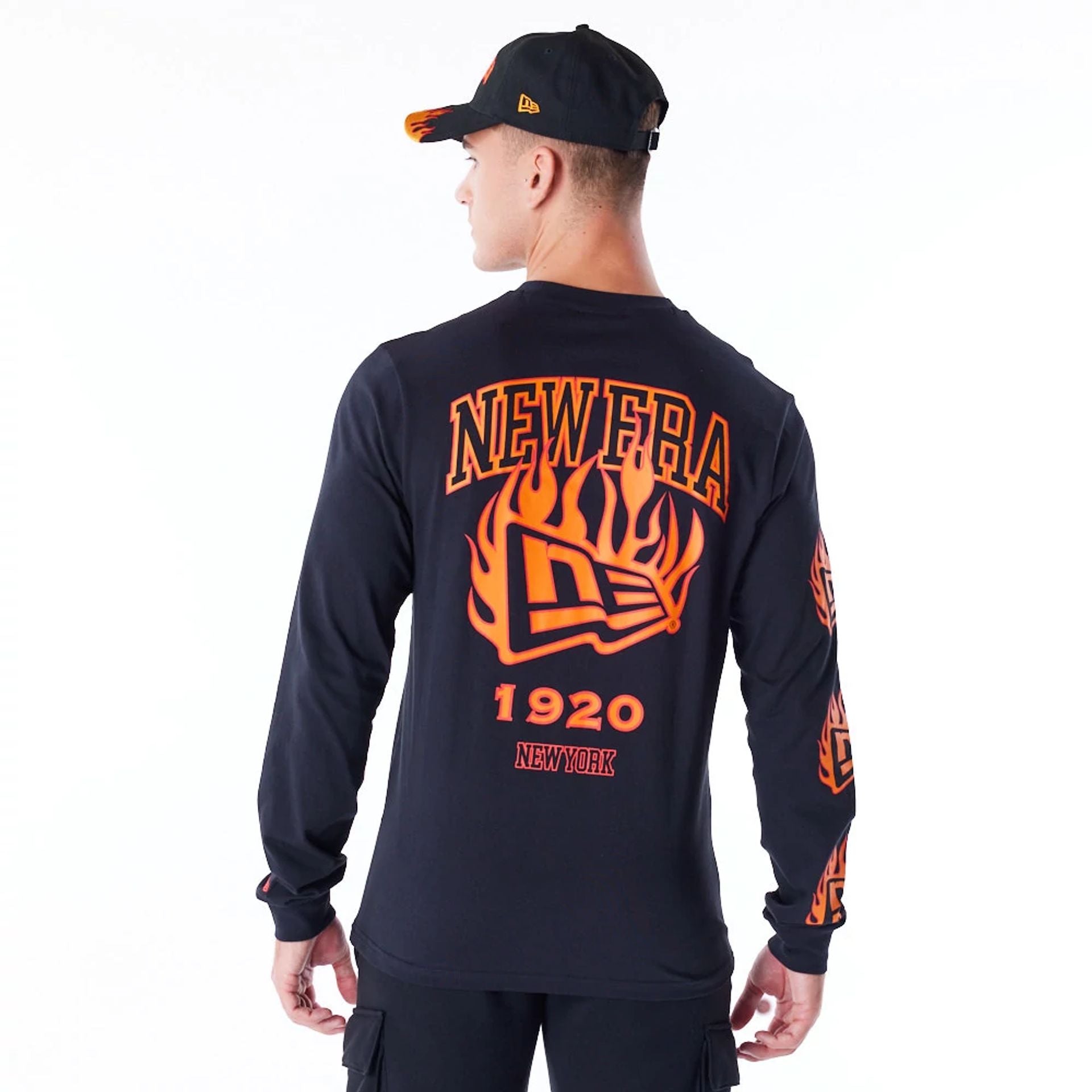 The Male model is wearing New Era Flag Flame Black Long Sleeve T-Shirt 7