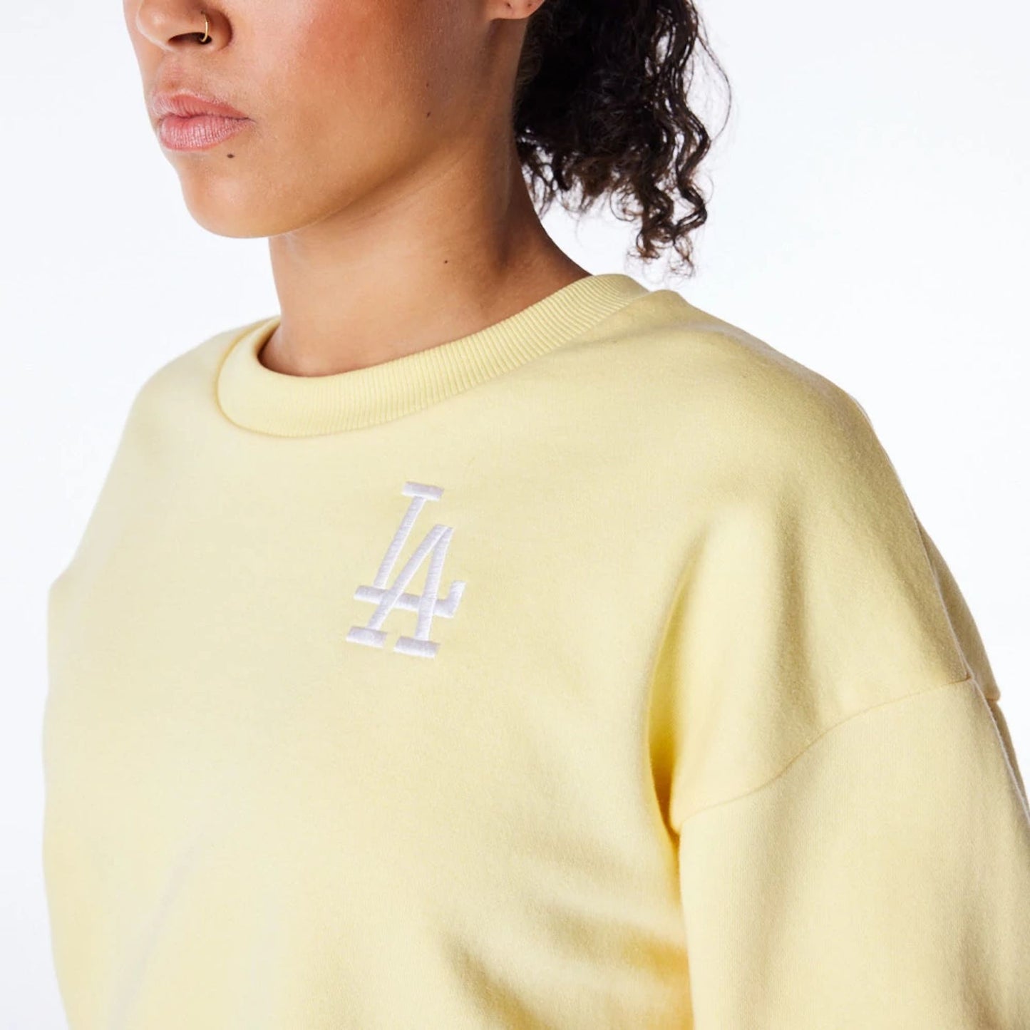 The Female model is wearing LA Dodgers Womens MLB League Essential Pastel Yellow Crop Crew Neck Sweatshirt 6